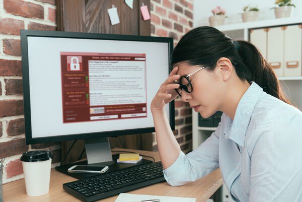 Home Cyber Insurance - Woman Stressed While Sitting at Her Home Office After Finding Out Her Computer Has a Virus Attack