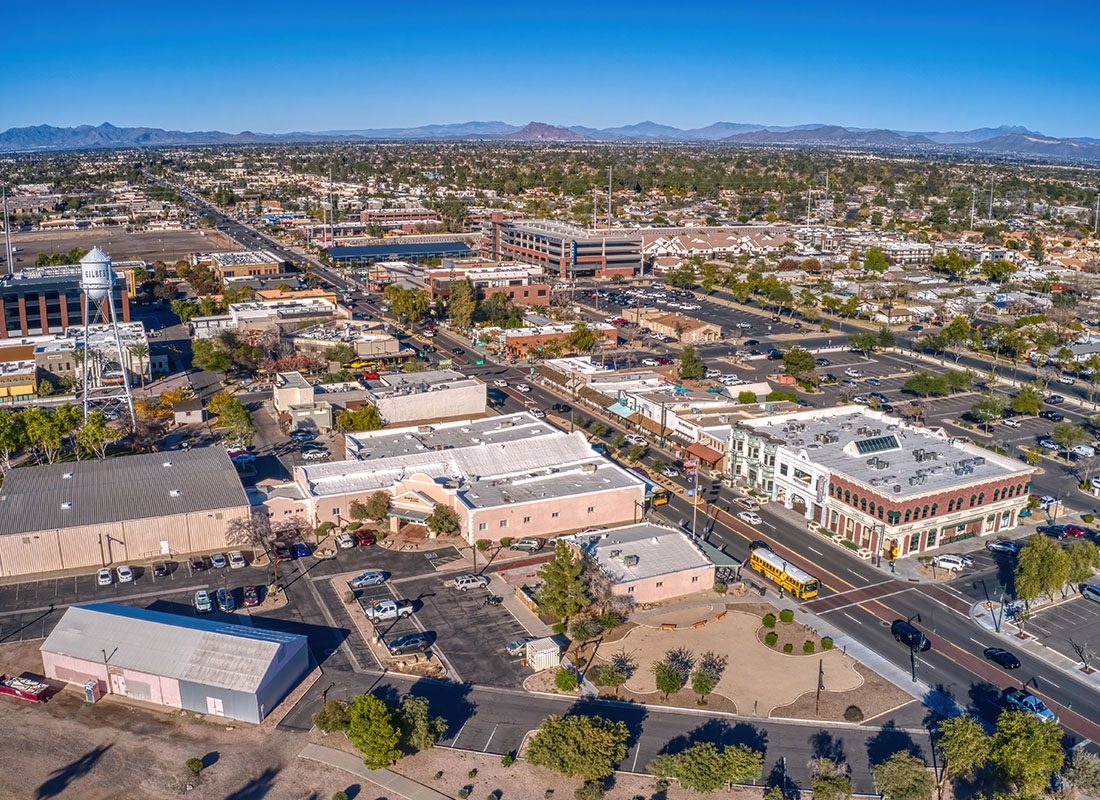 Gilbert, AZ - Aerial View of Gilbert, AZ With Mountain Ranges in the Background on a Sunny Day